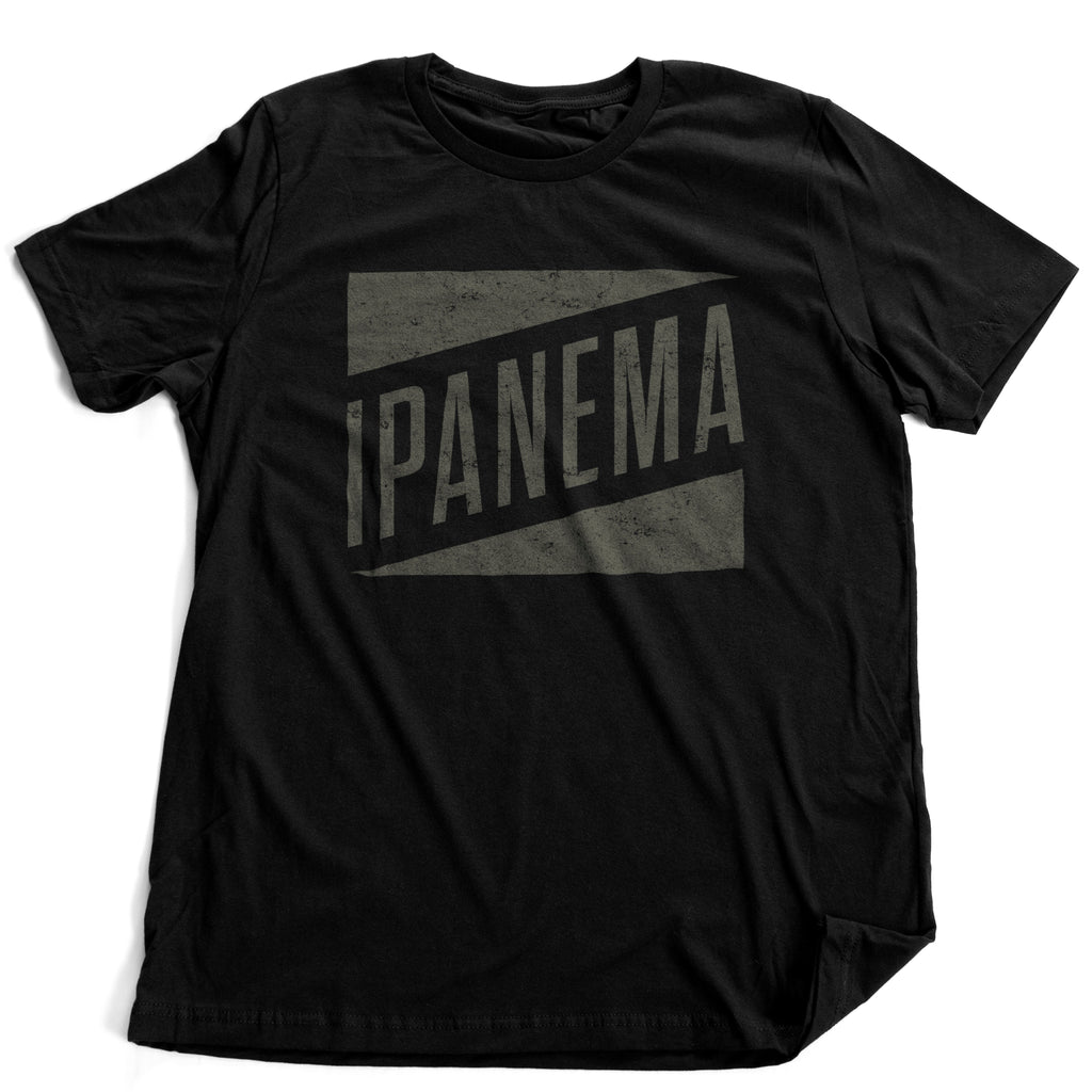 A fashionable, classic, retro design graphic t-shirt, featuring the bold typography that reads "IPANEMA" in a 60s-style diagonal banner orientation, dropping out of a solid rectangular, weathered block.