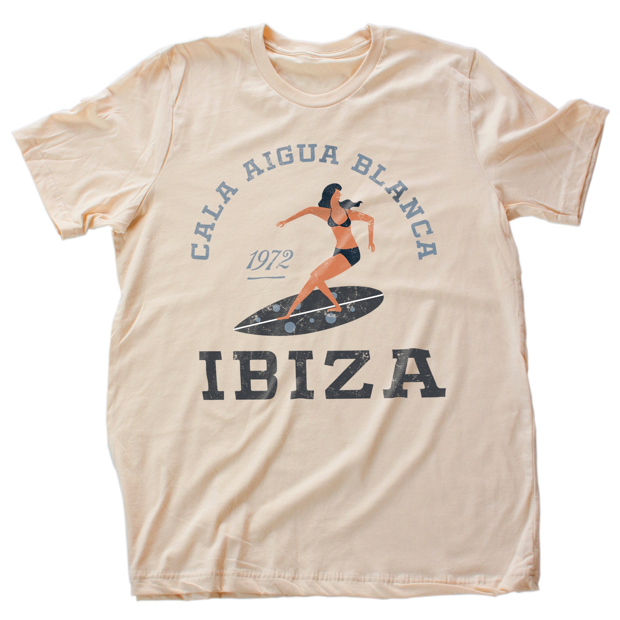 Vintage-inspired retro graphic t-shirt for the primary Ibiza Surfing destination, Cala Aigua Blanca. The shirt features a stylish illustration of a woman wearing a bikini on a surfboard.