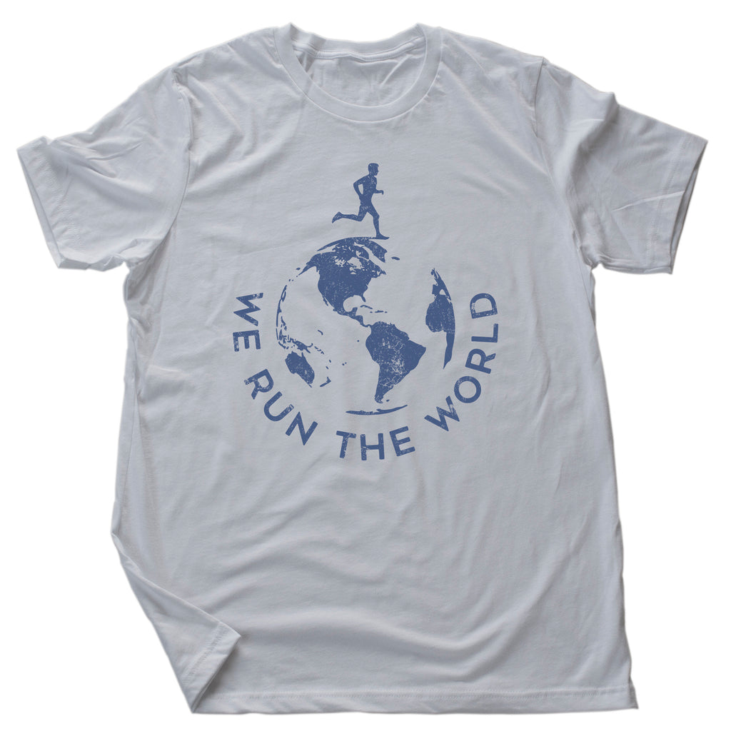 A graphic t-shirt for runners and joggers, with an illustration of the globe, and text encircling it that reads "We Run the World" as a double-entendre about running and dominating.