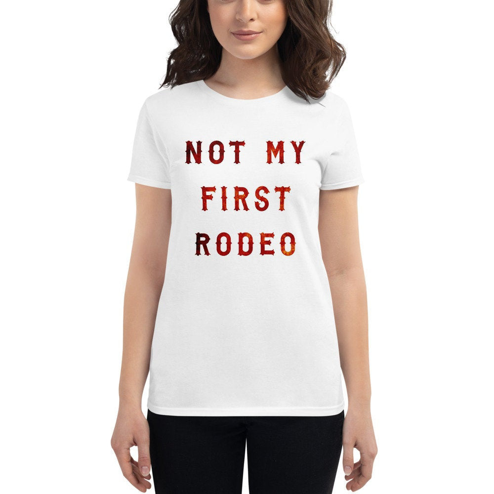 Fashionable, sarcastic, classic women's cut t-shirt featuring graphic of typography that reads "Not my first rodeo" in a beautiful, mottled bold custom font.