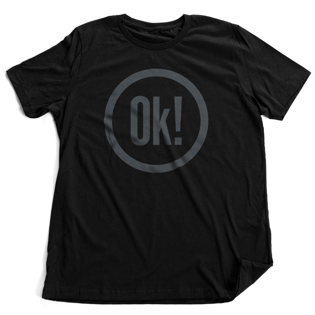 Sarcastic, retro design graphic t-shirt featuring the word "OK!" in large, bold typography, within a thick-lined circle.