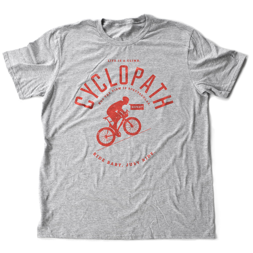 Classic graphic t-shirt featuring a cyclist in training, with the sarcastic, humorous "Cyclopath" text in an arch above it. With the tagline "Life is a climb" and "Ride baby, just ride" around it.