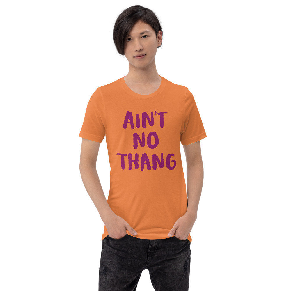 Bold graphic t-shirt with the sarcastic words "Ain't No Thang" in a painted, graffiti style.