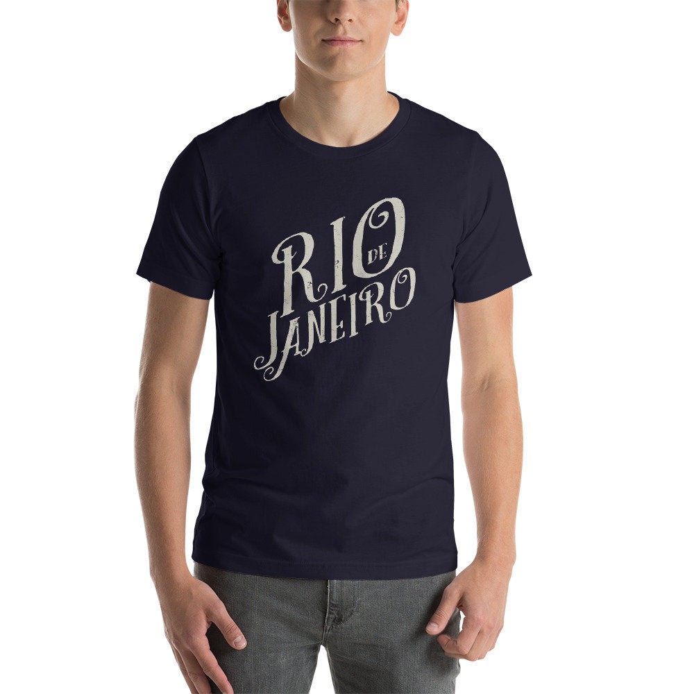 Fashionable graphic t-shirt with hand-lettered typography of "Rio de Janeiro" typeset diagonally. 