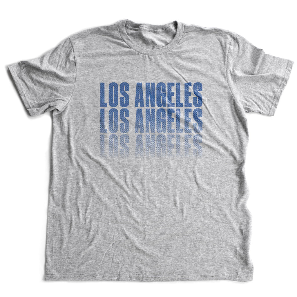 Stylish retro-design graphic t-shirt with "LOS ANGELES" repeated three times in a stack, with a benday pattern fade-out toward the bottom.
