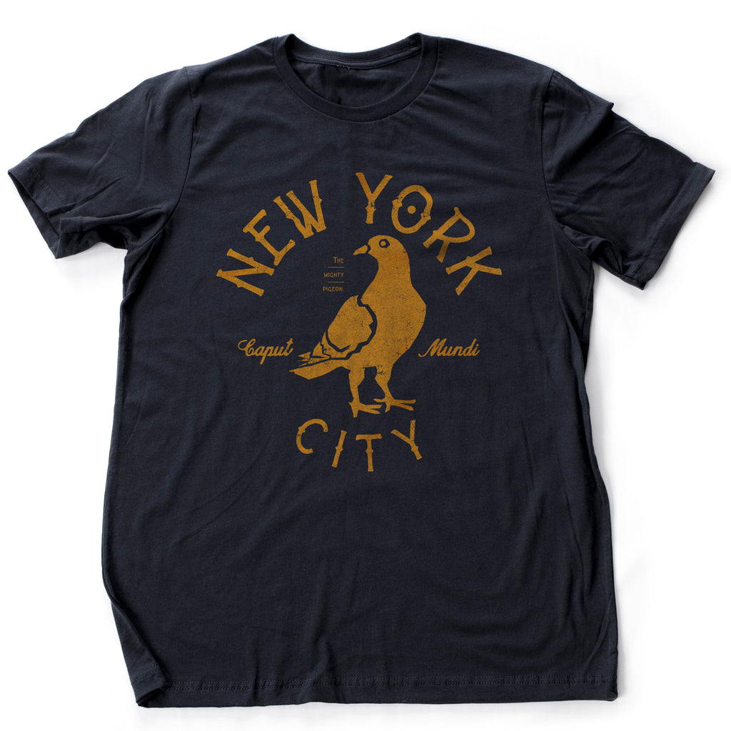 Classic, retro styled, vintage-inspired graphic t-shirt sarcastically featuring the illustration of a pigeon, encircled by the words "NEW YORK CITY" and the Latin nickname for NYC, "Caput Mundi," which means capital of the world, and smaller type that captions "The mighty pigeon"