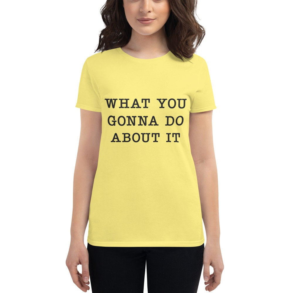 Graphic t-shirt based on a television episode of Killing Eve, featuring the words "What You Gonna Do About It" worn by a character in a scene with Villainelle / Jodie Comer.