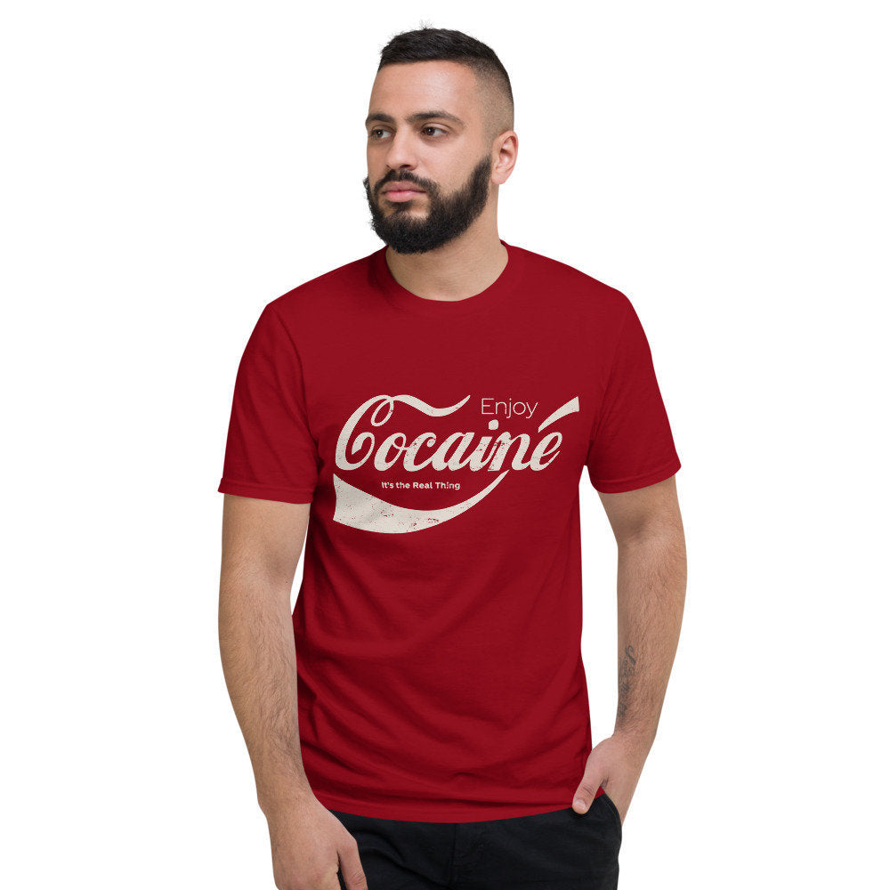 Sarcastic, joke, meme parody graphic t-shirt with a vintage/retro look, and the words "Enjoy Cocaine" in a mock Coca-Cola logo treatment.